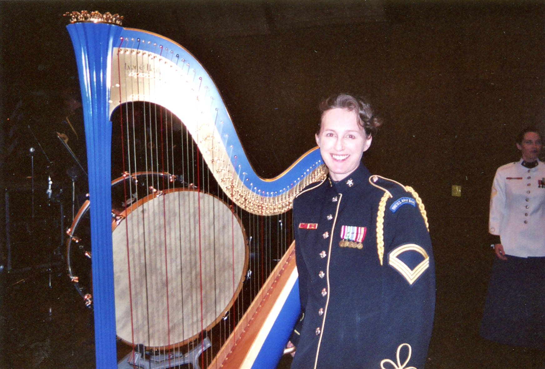Person in military dress playing a harp.